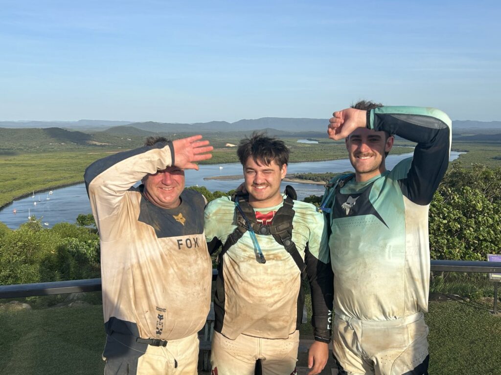 Grant, Max and Murray at a lookout over the Endeavour River, dust and mud on every inch of their gear