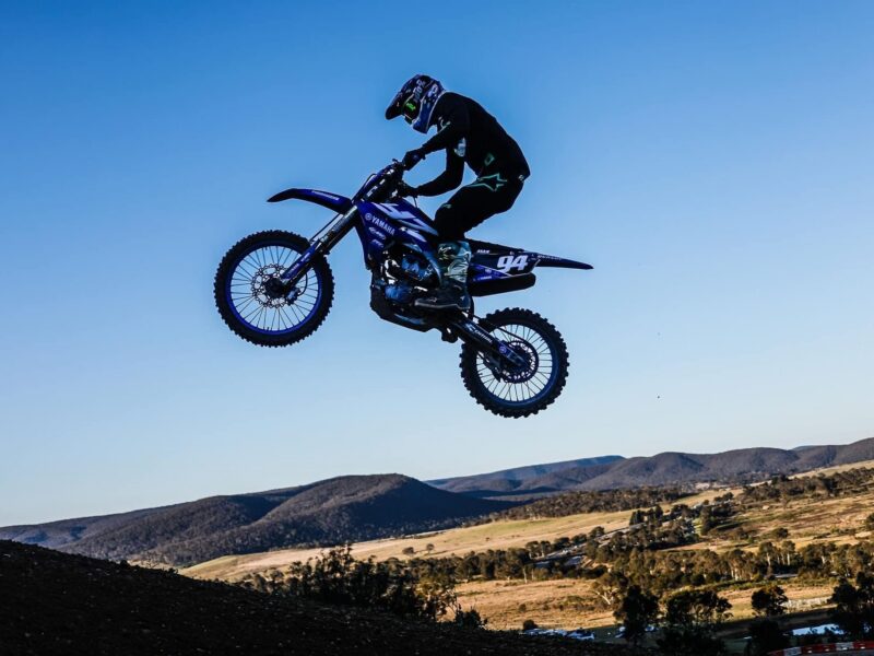 Max Wood mid-whip on his motocross bike
