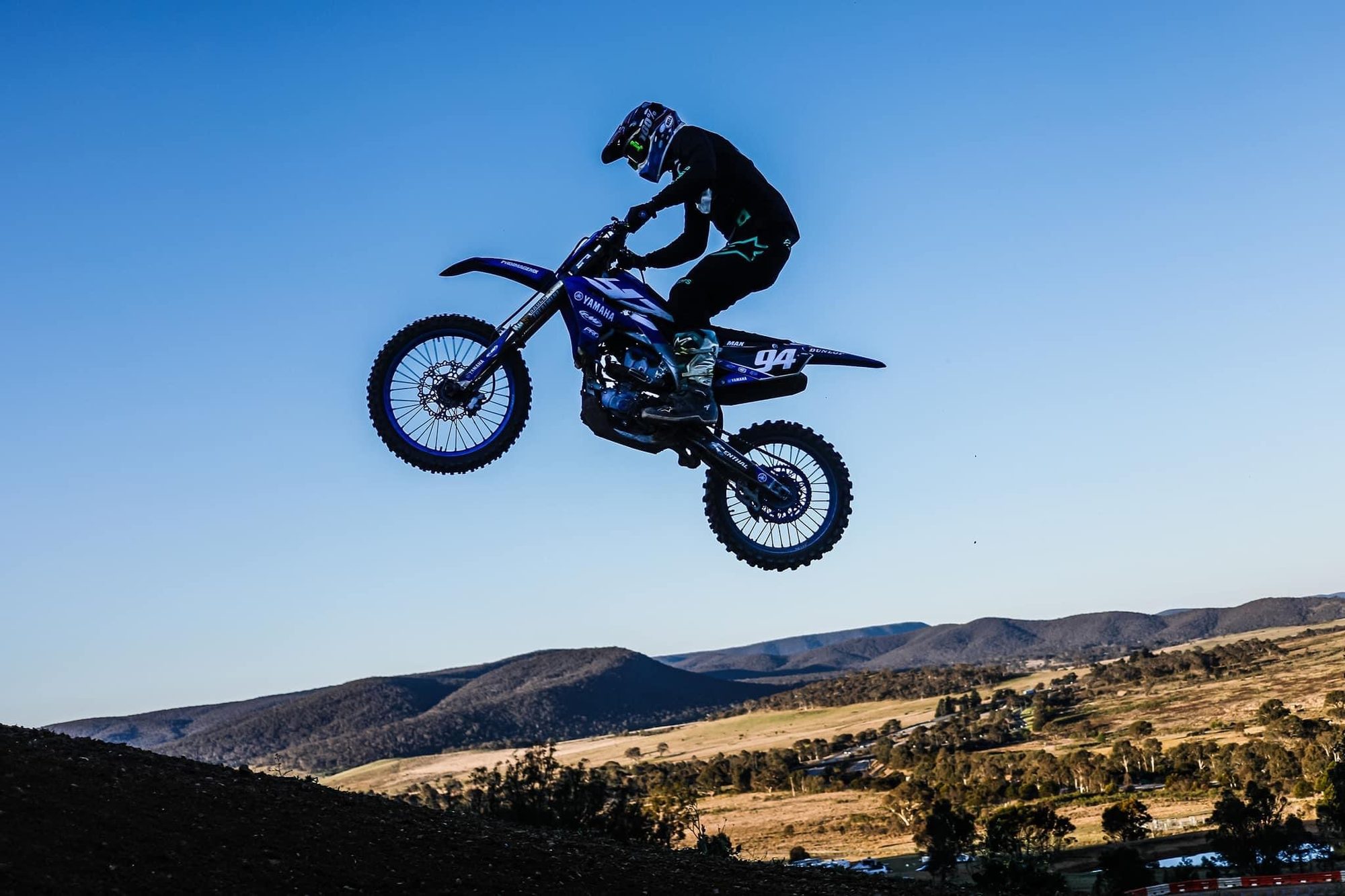 Max Wood mid-whip on his motocross bike